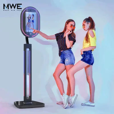 An MWE Mirror Photo Booth is shown as a full-length interactive imaging display.
